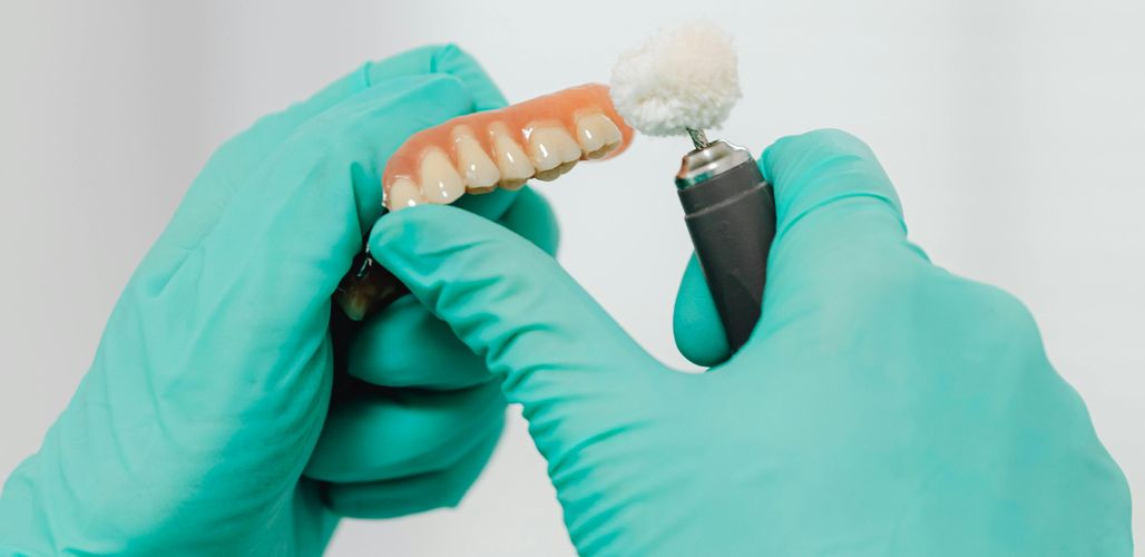 Image of a denture being cleaned and polished